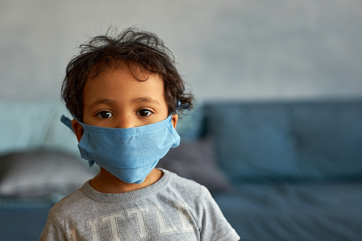 Portrait of a boy in mask at home